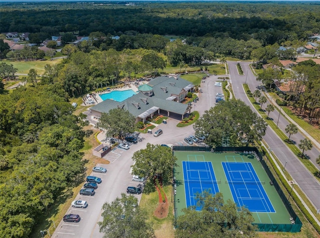 birds eye view of property with a view of trees