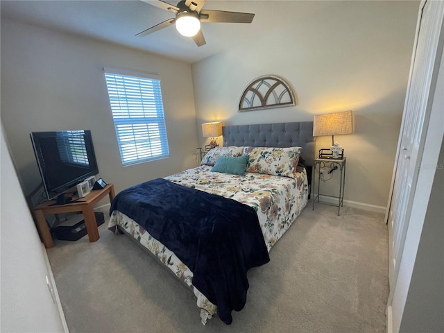 carpeted bedroom with baseboards and a ceiling fan