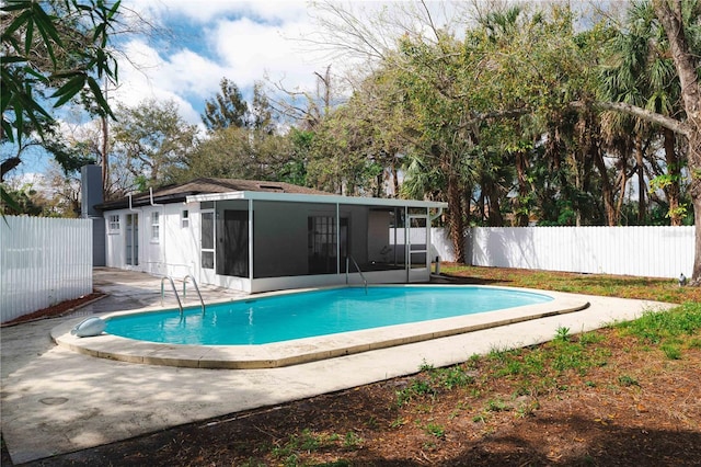 view of pool with a fenced in pool, a sunroom, and a fenced backyard