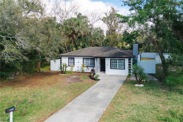 single story home with a front yard, fence, a chimney, and stucco siding