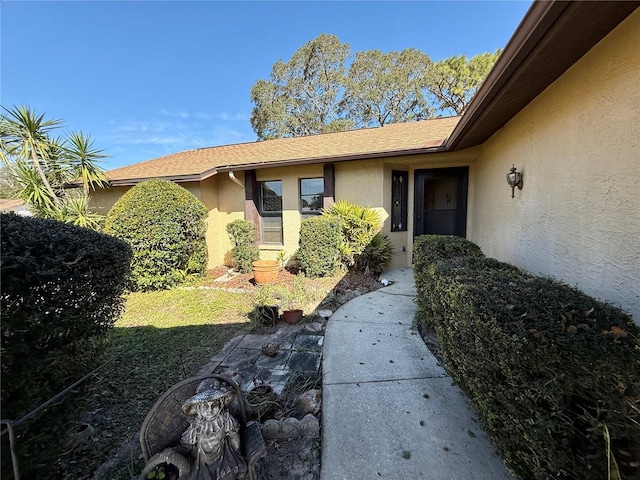 property entrance with stucco siding