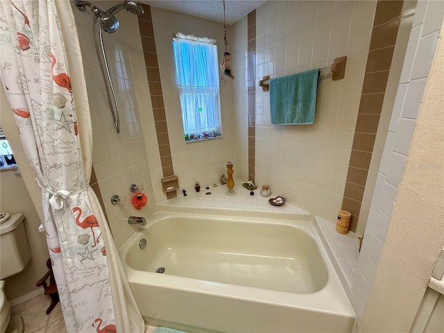 bathroom featuring a textured ceiling, toilet, and tile patterned floors