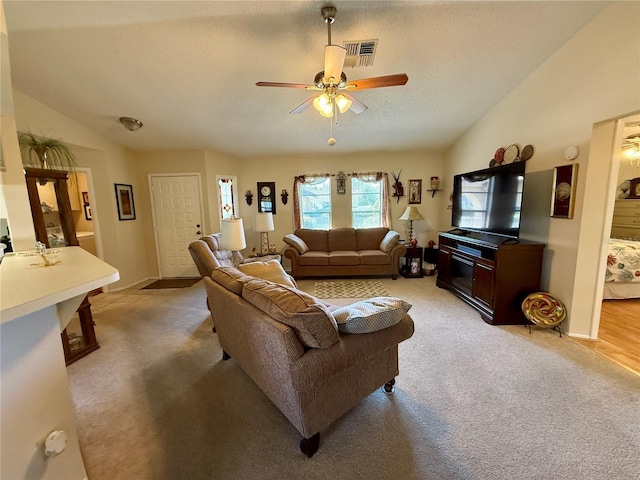 living room featuring lofted ceiling, light carpet, and visible vents