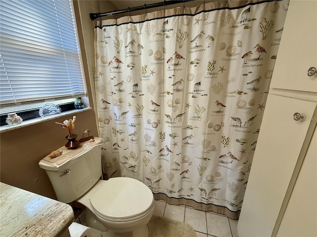 full bathroom with a shower with shower curtain, tile patterned flooring, and toilet