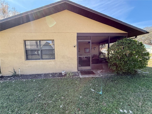 view of front of home with a front yard and stucco siding