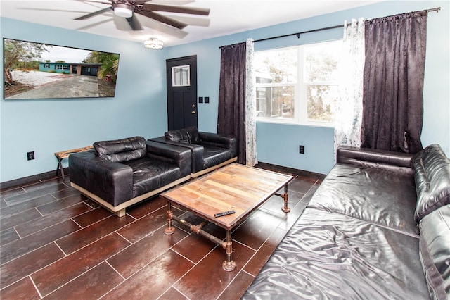 living room featuring wood tiled floor, ceiling fan, and baseboards