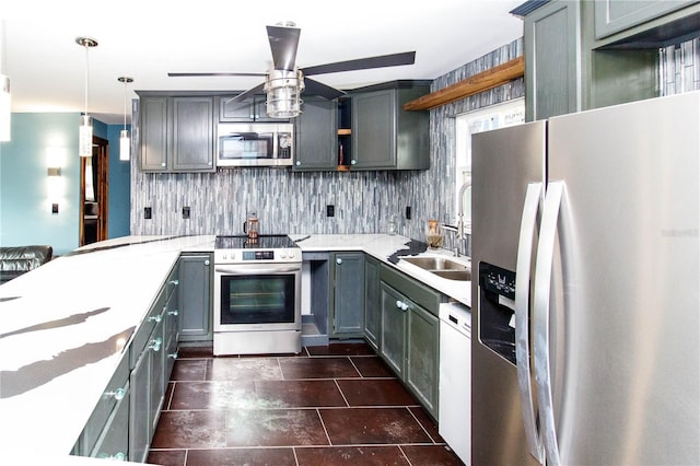 kitchen featuring gray cabinetry, stainless steel appliances, a sink, backsplash, and open shelves