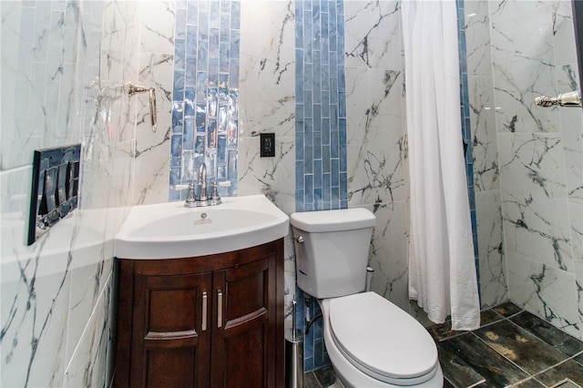 bathroom featuring toilet, tile walls, and vanity