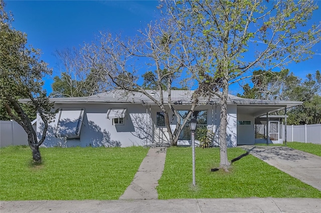 single story home with stucco siding, an attached carport, concrete driveway, and a front yard