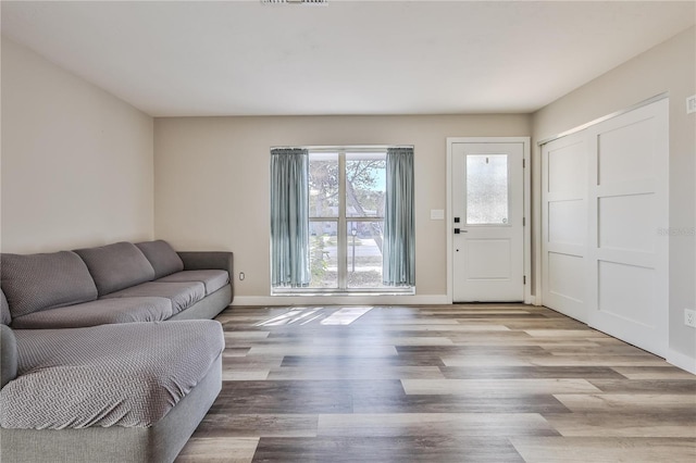 living area featuring baseboards and wood finished floors