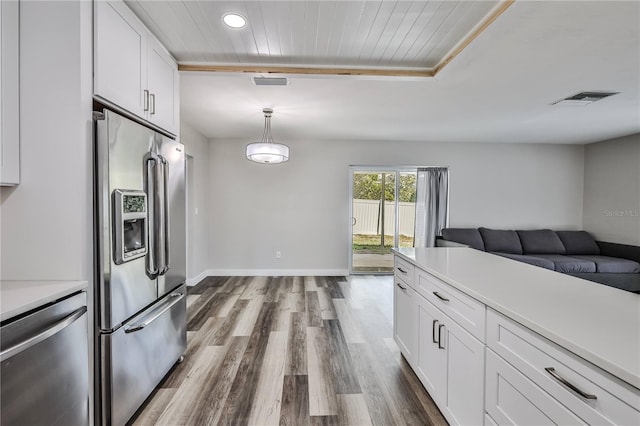 kitchen featuring stainless steel appliances, light countertops, visible vents, and white cabinetry