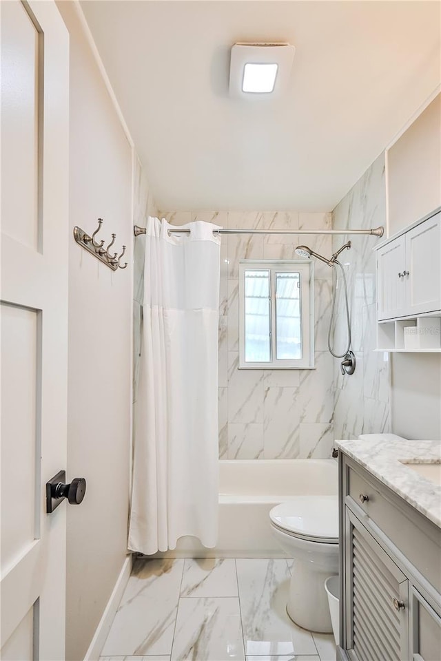 full bath featuring marble finish floor, toilet, shower / bath combo, vanity, and baseboards