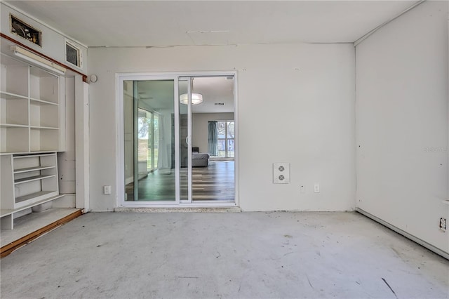 spare room with concrete flooring