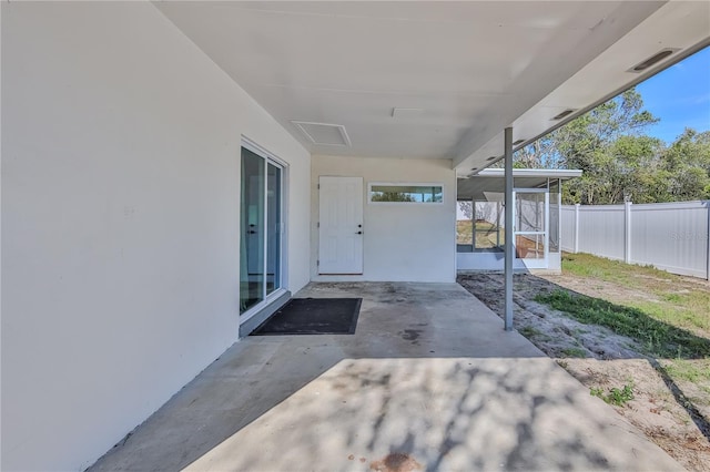 view of patio / terrace featuring a sunroom and fence