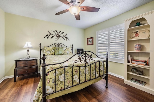 bedroom with a ceiling fan, wood-type flooring, a textured ceiling, and baseboards