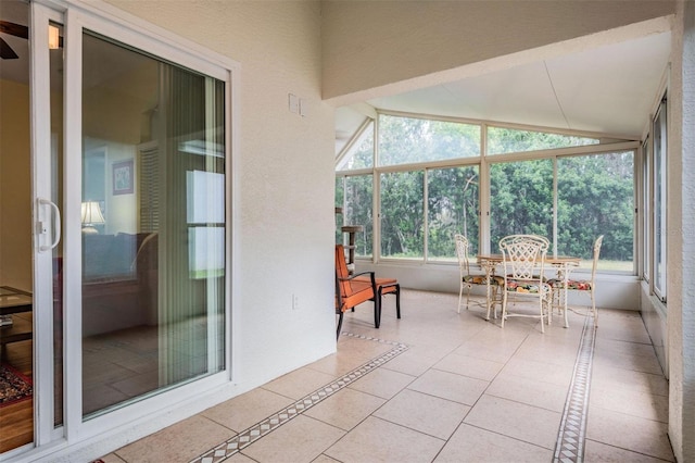 sunroom / solarium featuring vaulted ceiling