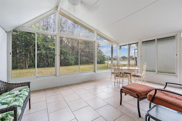 sunroom / solarium featuring vaulted ceiling with beams