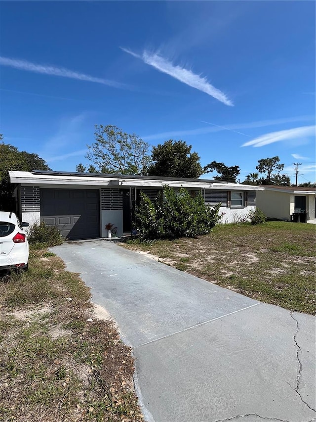 ranch-style home featuring driveway and an attached garage