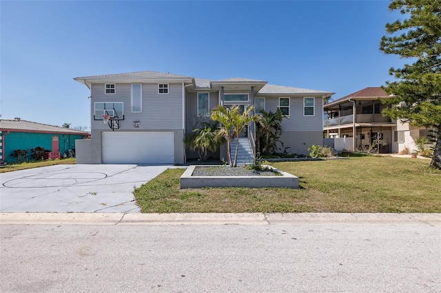 view of front of property with a front lawn, driveway, and an attached garage