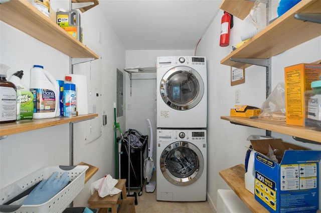 laundry area with laundry area and stacked washer / drying machine