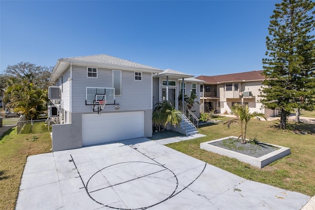 view of front facade featuring driveway, an attached garage, a front lawn, central AC, and stucco siding