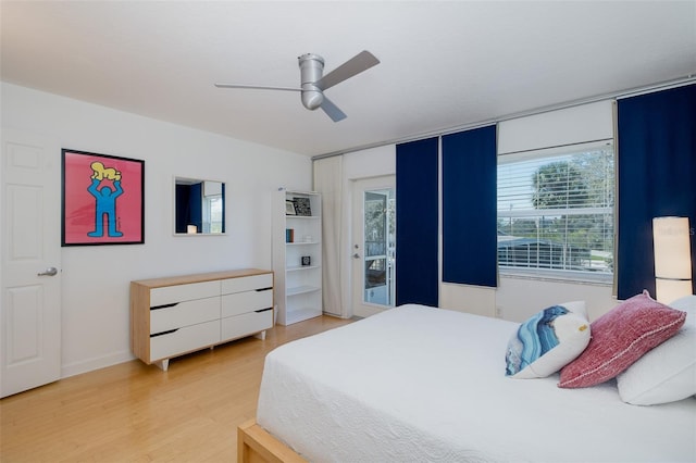 bedroom with access to exterior, light wood-style floors, and ceiling fan