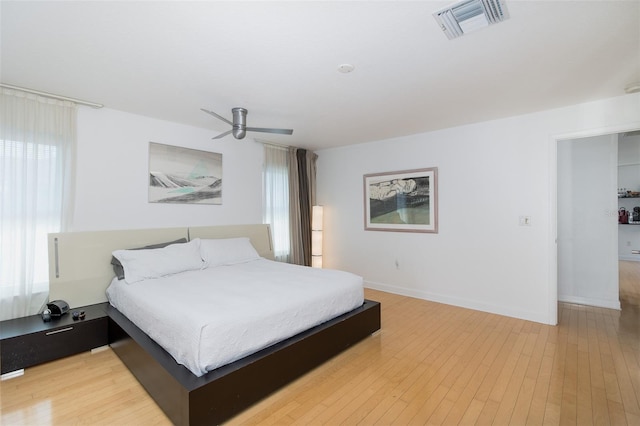 bedroom with light wood-type flooring, visible vents, baseboards, and multiple windows