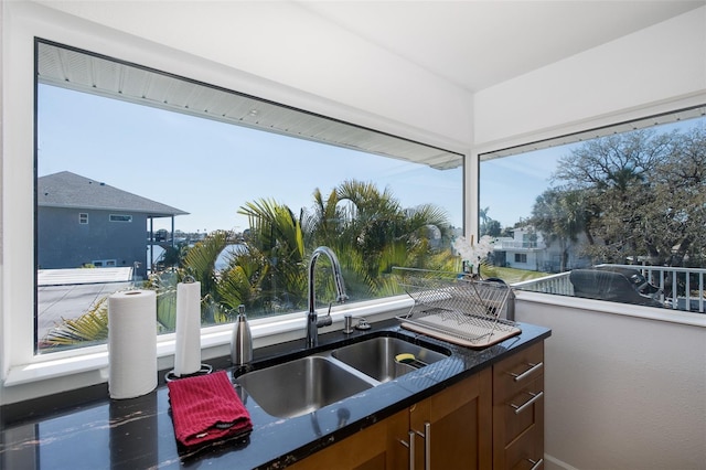 kitchen featuring dark countertops and a sink