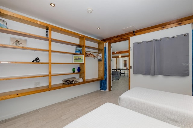 bedroom featuring wood finished floors and recessed lighting