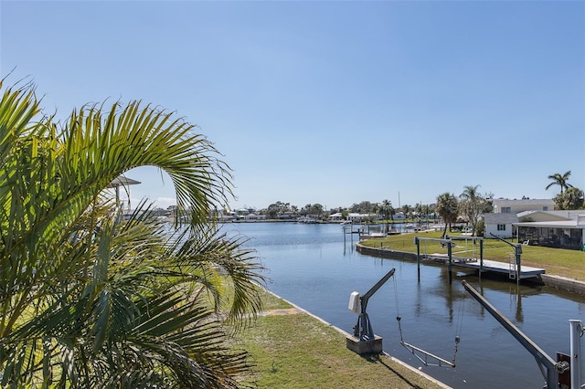 dock area featuring a water view and a yard