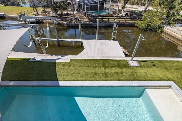 view of dock featuring a lawn, a water view, a lanai, and an outdoor pool