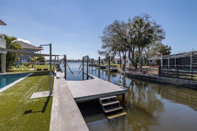 dock area featuring a water view and a yard