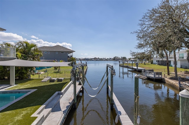 dock area with a water view and a yard