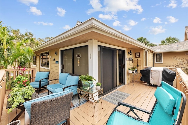 wooden deck with outdoor lounge area and grilling area