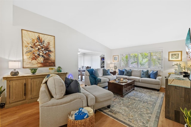 living room with lofted ceiling and light wood finished floors