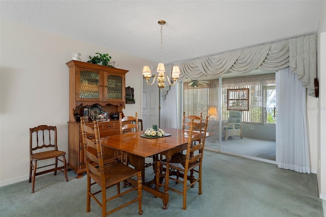 carpeted dining area with baseboards, a textured ceiling, and a chandelier