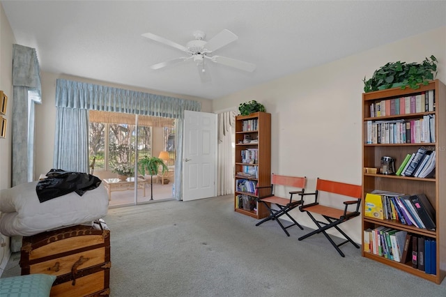 sitting room featuring carpet and a ceiling fan