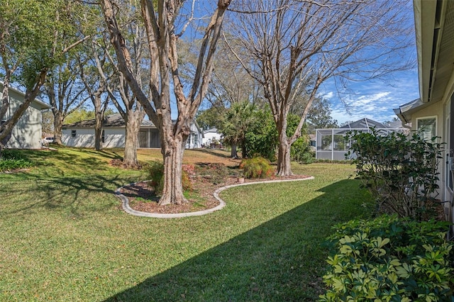 view of yard featuring glass enclosure