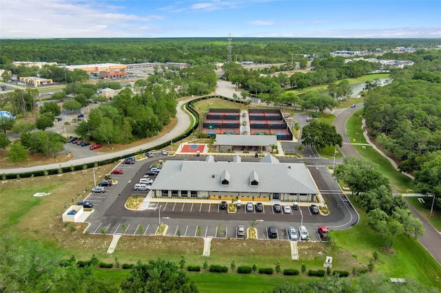 drone / aerial view with a water view and a wooded view