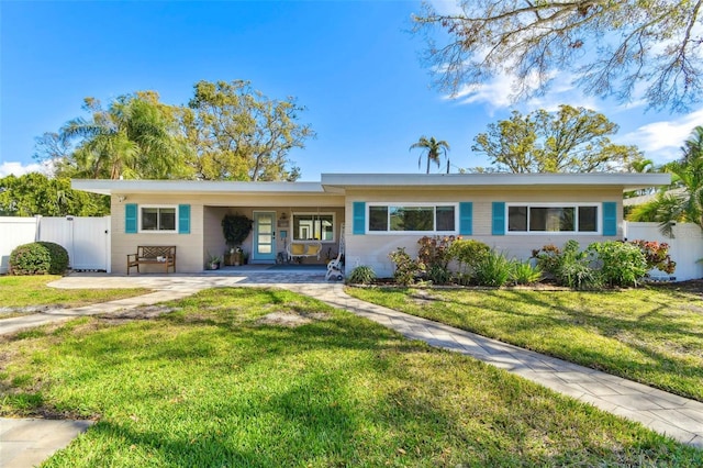 single story home featuring fence and a front yard