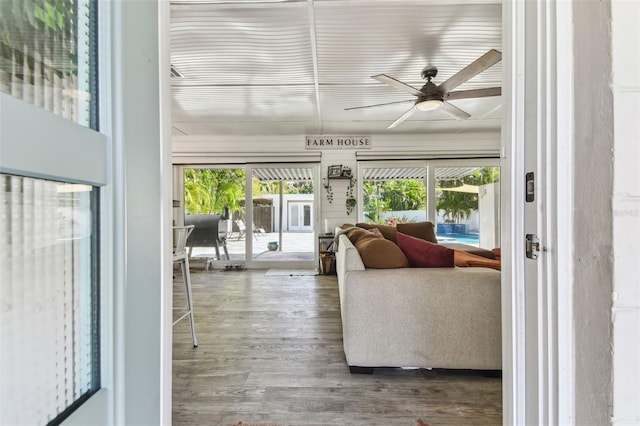 living area featuring a ceiling fan and wood finished floors