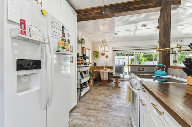 kitchen with visible vents, white appliances, light wood-style flooring, and white cabinetry