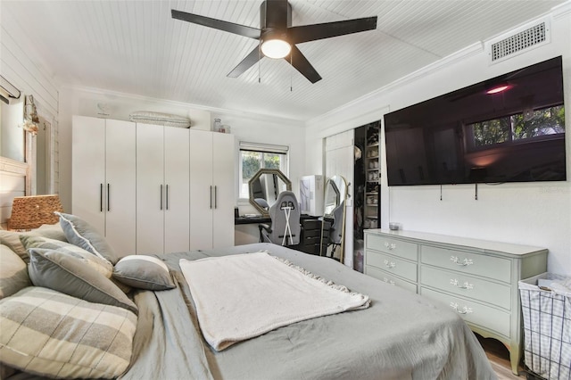 bedroom featuring ornamental molding, visible vents, and ceiling fan