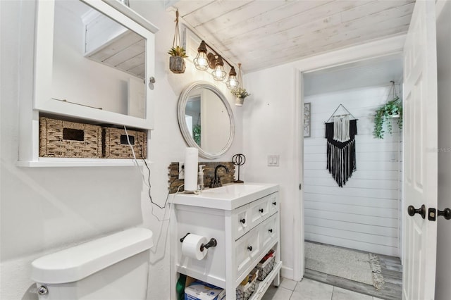 bathroom featuring lofted ceiling, toilet, wood ceiling, vanity, and tile patterned flooring