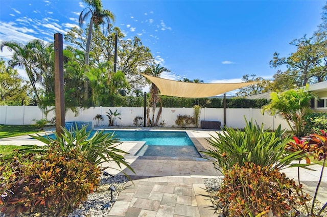 view of swimming pool with a fenced in pool, a fenced backyard, and a patio