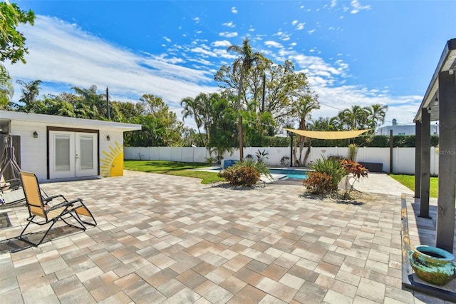 view of patio featuring a fenced backyard, a fenced in pool, and french doors