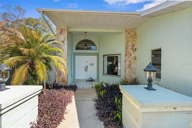 property entrance featuring stone siding and stucco siding