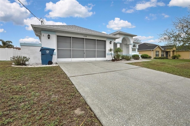 view of front of home with fence, an attached garage, stucco siding, a front lawn, and concrete driveway