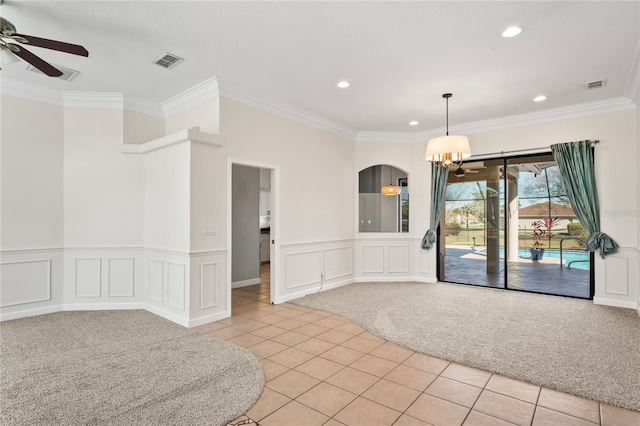 unfurnished room with light tile patterned floors, visible vents, light colored carpet, ornamental molding, and ceiling fan with notable chandelier