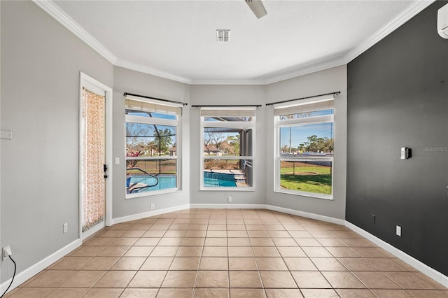 unfurnished room featuring ornamental molding, baseboards, and light tile patterned floors